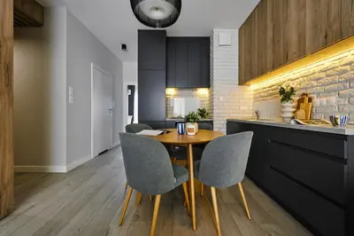 a kitchen with a wooden table and chairs at Velvet Dreams Apartments 49 in Kraków