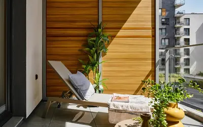 a balcony with a bench and a wooden wall at Velvet Dreams Apartments 49 in Kraków