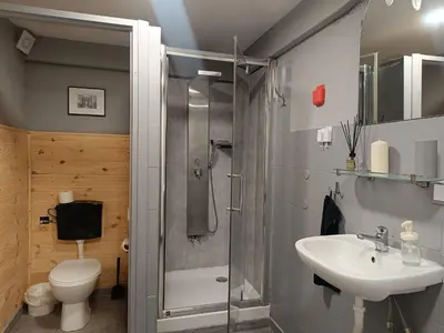a bathroom with a shower and a toilet and a sink at Pokój kapsułowy 7 in Kraków