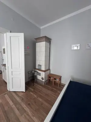 a living room with a couch with a remote control at Topolova Apartament - Stare Miasto, 10 min od Rynku in Kraków