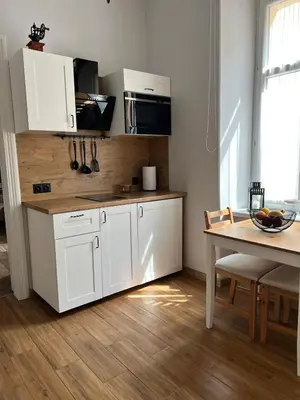 a kitchen with a table and a dining room at Topolova Apartament - Stare Miasto, 10 min od Rynku in Kraków