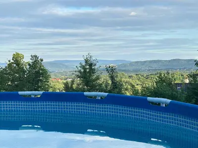 a swimming pool with a view of the mountains at Szumią Dęby - Marcyporęba in Marcyporęba