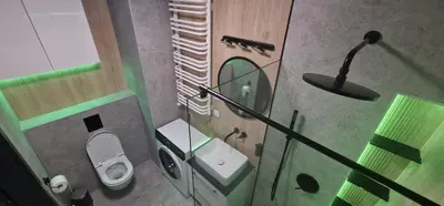 a small bathroom with a toilet and a mirror at Sunrise Apartament in Kraków