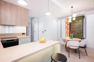 a kitchen and dining room with a table and chairs at Apartment Grodzka 27 in Kraków