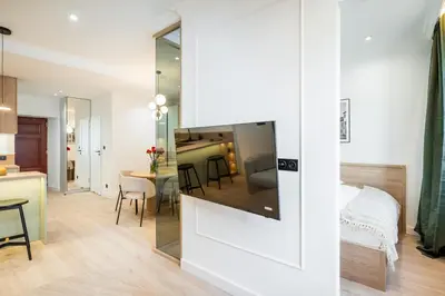 a room with a kitchen and a living room at Apartment Grodzka 27 in Kraków