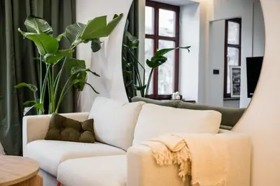 a living room with a white couch and plants at Apartment Grodzka 27 in Kraków