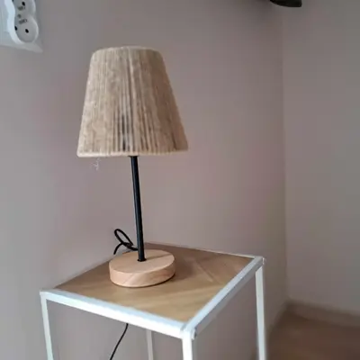 a lamp sitting on top of a white table at Niwy8Rooms in Oświęcim