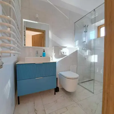 a bathroom with a sink and a toilet and a mirror at Niwy8Rooms in Oświęcim