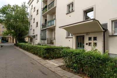 an empty street in front of a building at Grzegórzki Comfort Apartment by BookingHost in Kraków