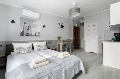a white kitchen with a white table and chairs at NEXT TO Royal Castle Elegant Apartments Kraków Old Town in Kraków