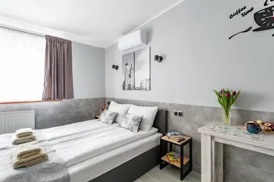 a kitchen with white cabinets and a table at NEXT TO Royal Castle Elegant Apartments Kraków Old Town in Kraków