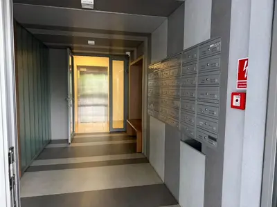a hallway of an office building with a door and a hallway sidx sidx at Apartament Pod Areną in Kraków