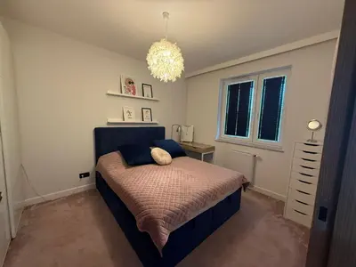 a bedroom with a bed with a stuffed animal on it at Apartament Pod Areną in Kraków