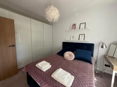 a bedroom with a bed with two pillows on it at Apartament Pod Areną in Kraków