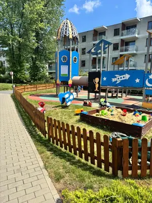 a playground in a park with a fence at Apartament Pod Areną in Kraków