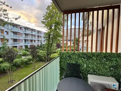 an apartment balcony with a view of a building at Apartament Pod Areną in Kraków