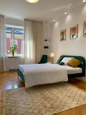 a bedroom with a large bed and a window at Gorka Apartament - Old Town Krakow in Kraków