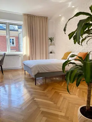 a bedroom with a bed and a potted plant at Gorka Apartament - Old Town Krakow in Kraków