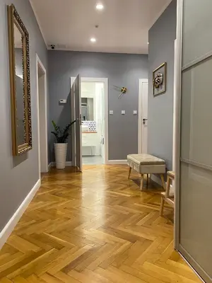 a hallway with a wooden floor and a mirror at Gorka Apartament - Old Town Krakow in Kraków