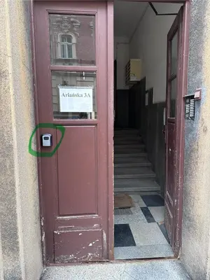 a red door with a sign on it in a hallway at Gorka Apartament - Old Town Krakow in Kraków