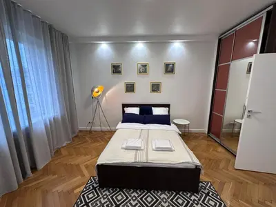 a bedroom with a large bed with blue pillows at Gorka Apartament - Old Town Krakow in Kraków