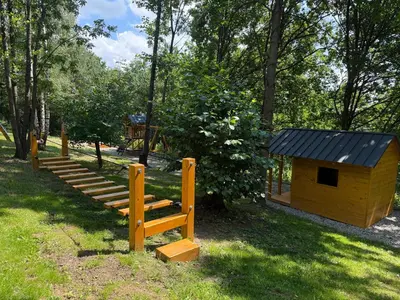a small yellow dog house with a wooden staircase at Julianowe Wzgórze in Czchów
