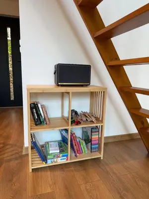 a book shelf with a tv on it next to a staircase at Julianowe Wzgórze in Czchów