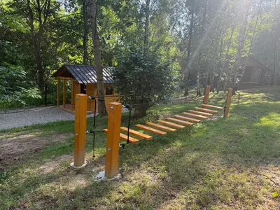 a playground with a wooden set of steps and a shelter at Julianowe Wzgórze in Czchów