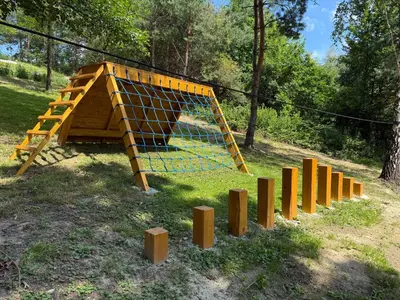 a play structure with a net and wooden posts at Julianowe Wzgórze in Czchów