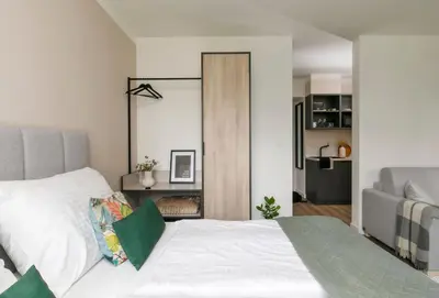 a bedroom with a white bed and a sliding door at Zeitraum Raclawicka in Kraków