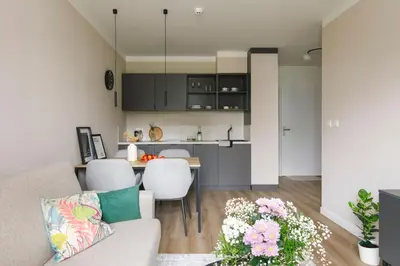 a living room and kitchen with a couch and a table at Zeitraum Raclawicka in Kraków