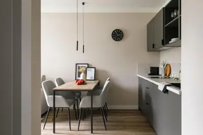 a kitchen and dining room with a table and chairs at Zeitraum Raclawicka in Kraków