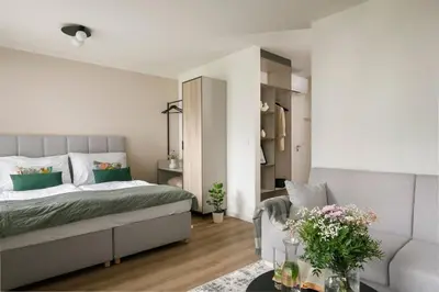 a bedroom with a bed and a couch at Zeitraum Raclawicka in Kraków