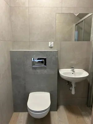 a bathroom with a toilet and a sink at Mieszkanie w zaciszu in Kraków
