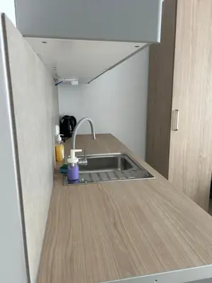 a kitchen with a sink and a wooden counter top at Mieszkanie w zaciszu in Kraków