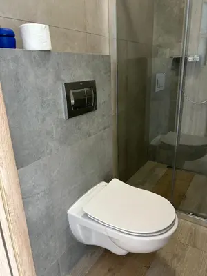 a bathroom with a toilet and a shower at Mieszkanie w zaciszu in Kraków
