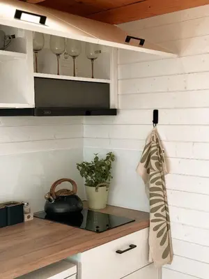 a kitchen with white cabinets and a counter top at Horyzont Spokoju in Podobin