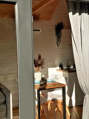 a table and chairs in a room with a kitchen at Horyzont Spokoju in Podobin