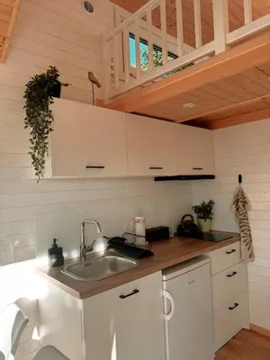 a kitchen with a sink and a wooden ceiling at Horyzont Spokoju in Podobin