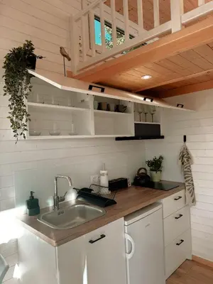 a kitchen with white cabinets and a sink at Horyzont Spokoju in Podobin