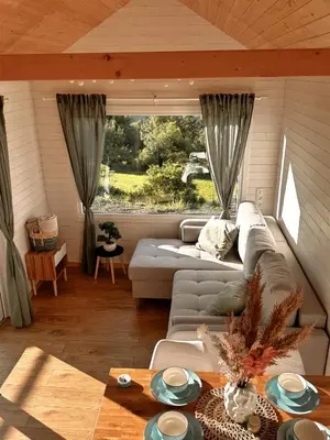 a living room with a couch and a table at Horyzont Spokoju in Podobin