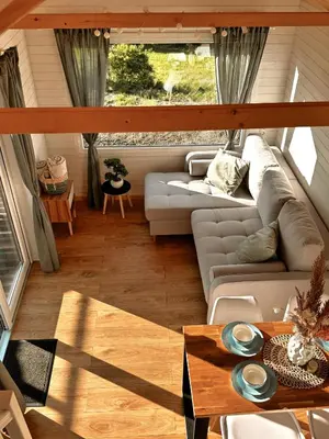 a living room with a couch and a table at Horyzont Spokoju in Podobin
