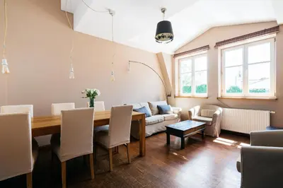 a living room with a table and a couch at Native Apartments Sobieskiego 19 in Kraków