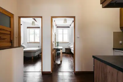 a kitchen and living room with a couch and a table at Native Apartments Sobieskiego 19 in Kraków