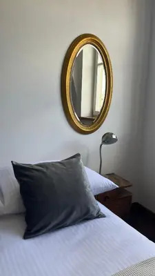 a bedroom with a bed with a mirror on the wall at Native Apartments Sobieskiego 19 in Kraków