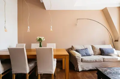 a living room with a table and a couch at Native Apartments Sobieskiego 19 in Kraków