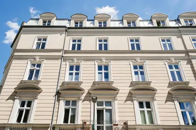 a large white building with many windows at Native Apartments Sobieskiego 19 in Kraków