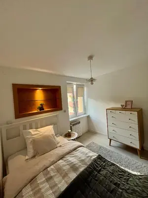 a bedroom with a bed and a dresser in it at Apartment Kraków-Stare Miasto in Kraków