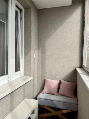a small room with a couch and two windows at Apartment Kraków-Stare Miasto in Kraków
