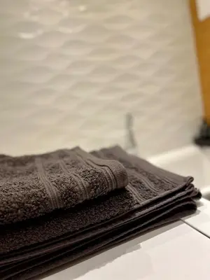 a pile of towels sitting on top of a counter at Apartment Kraków-Stare Miasto in Kraków